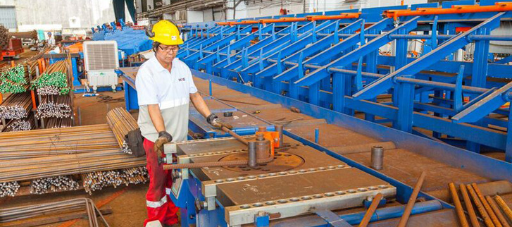 An operator uses a single bender to process rebar at HURE’s new facility.