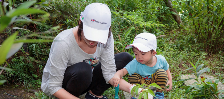 Participants planting seeds on the campus