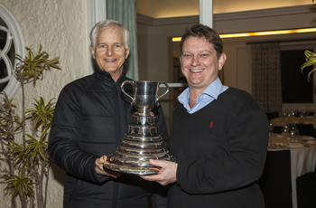 The winner of Scott Cup, Alex Jenkins from Cathay Pacific, receives the trophy from John Slosar.