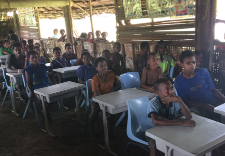 New classroom furniture delivered to a remote village in the Sepik River region.
