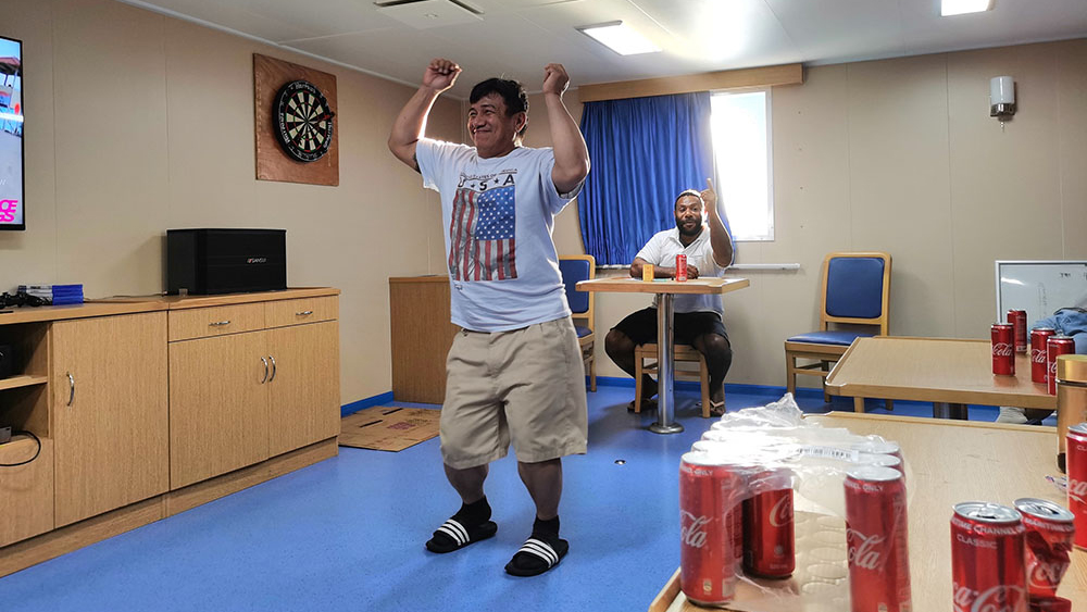 Crew member Soriano Leroy gets into the swing of a karaoke/dance session on Suva Chief.