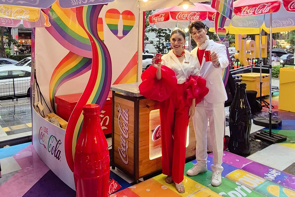 ThaiNamthip Coca-Cola staff hand out drinks along the parade route.