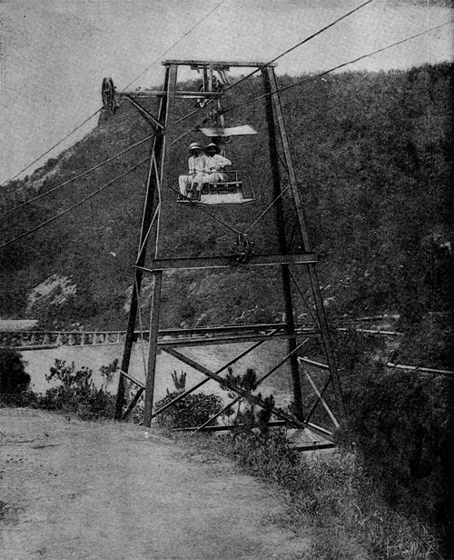 Two European staff cross the refinery’s reservoir in 1899. The unusual headgear worn by the man on the left is a variation on the standard-issue solar topee worn by Victorians in the tropics as a protection against the sun; this one was designed to facilitate a flow of air to the scalp.