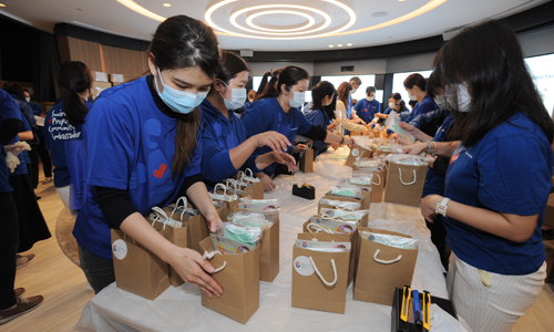 Swire Properties Community Ambassadors help package care-packs for frontline teams.