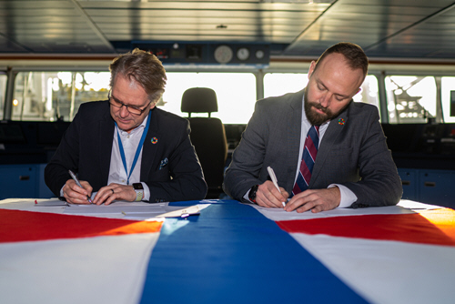 Mr Mats Vikholm, Head of Wind Farm Design, Vattenfall (left) and Mikkel Gleerup, CEO, SBO, (right) sign the contract on Pacific Osprey's bridge.