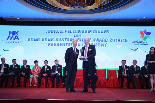 Swire Properties Chief Executive, Guy Bradley (right), receives the Grand Award recognising the company’s commitment to sustainability.