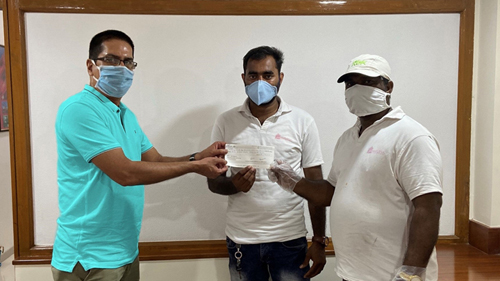 CNCo's Country Manager, Nithin Menon (left) hands over a cheque for 150,000 rupees (US$2,000) to volunteers from the Annapurna Movement.