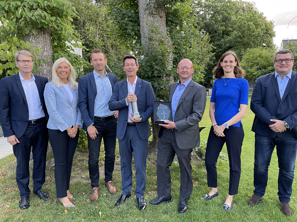 ALL NRG management – including CEO, Manfred Vonlanthen (fourth from left) and VP Offshore Wind, Sabine Weth (second from right) – celebrate the acquisition.