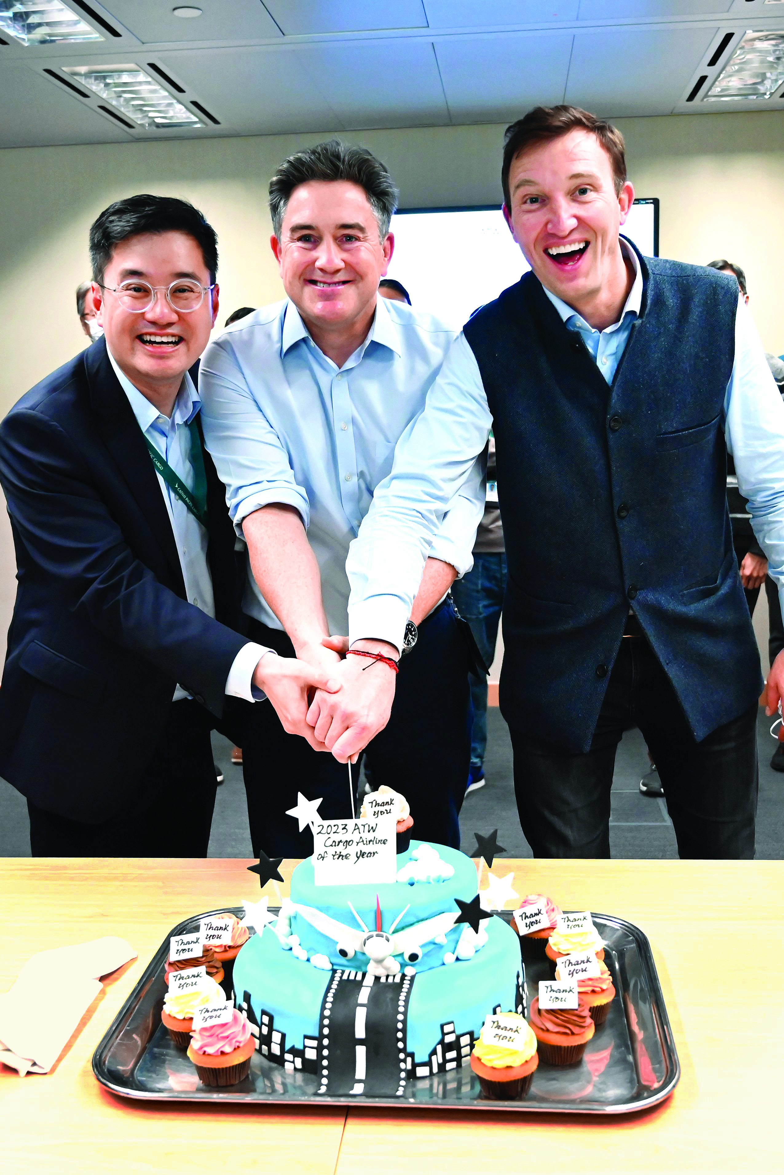 Cathay Pacific Director Cargo Tom Owen (centre) celebrates the win with GM Cargo Service Delivery Frosti Lau (left) and GM Cargo Commercial, George Edmunds. 