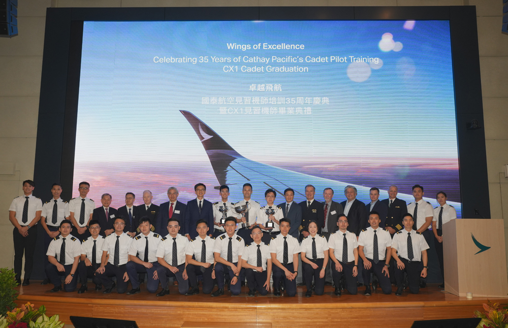 Hosted by Cathay Group CEO, Ronald Lam (back row, eighth from left), the 21 new graduates from the integrated training programme celebrate with guests from the Civil Aviation Department, PolyU and AeroGuard.