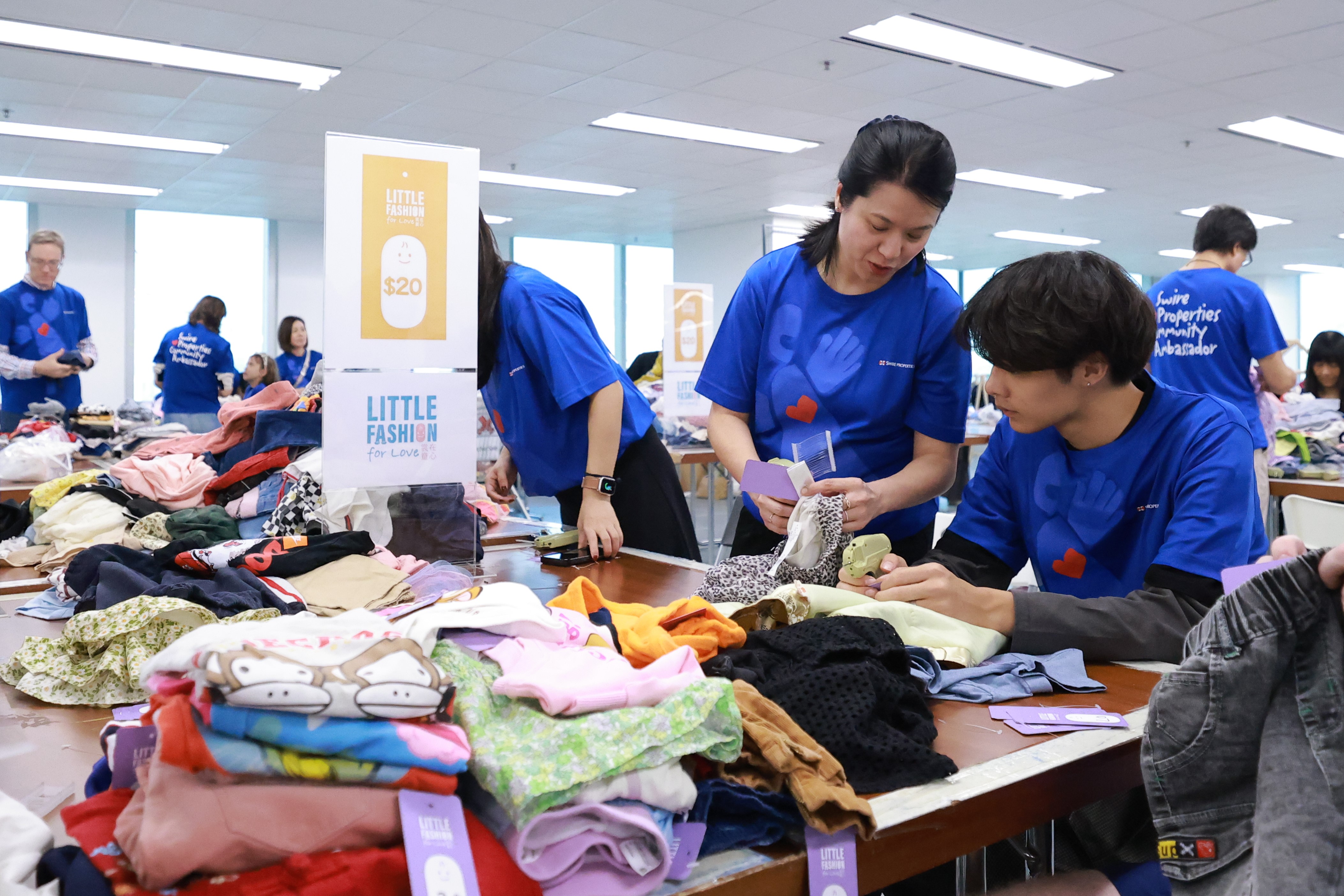 Bobo and her 17-year-old son sort and tag kidswear with fellow volunteers for the Little Fashion for Love charity sale.