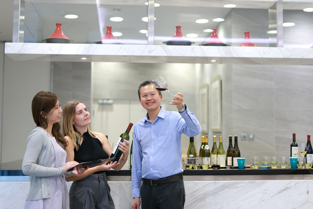 Ronald (right) and his teammates sample wines for upcoming inflight menus.